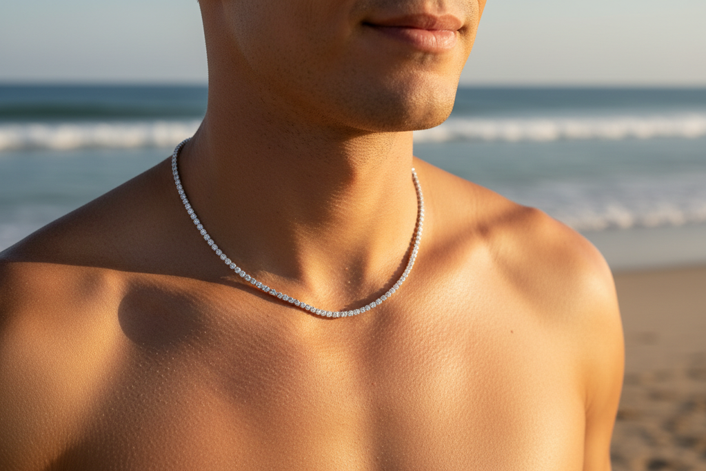 Lean man shirtless, beach setting, he has a thin moissanite tennis necklace on him, only up to the mans mouth is showing, the rest of his face isnt 